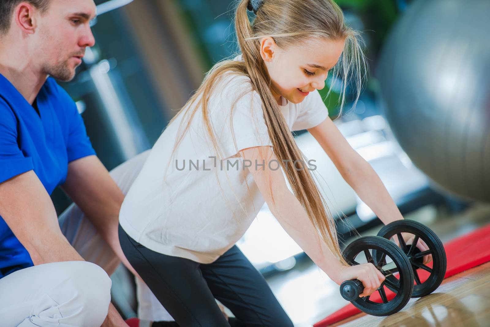 Children Rehabilitation Center. Little Girl Exercise with Medical Practitioner.