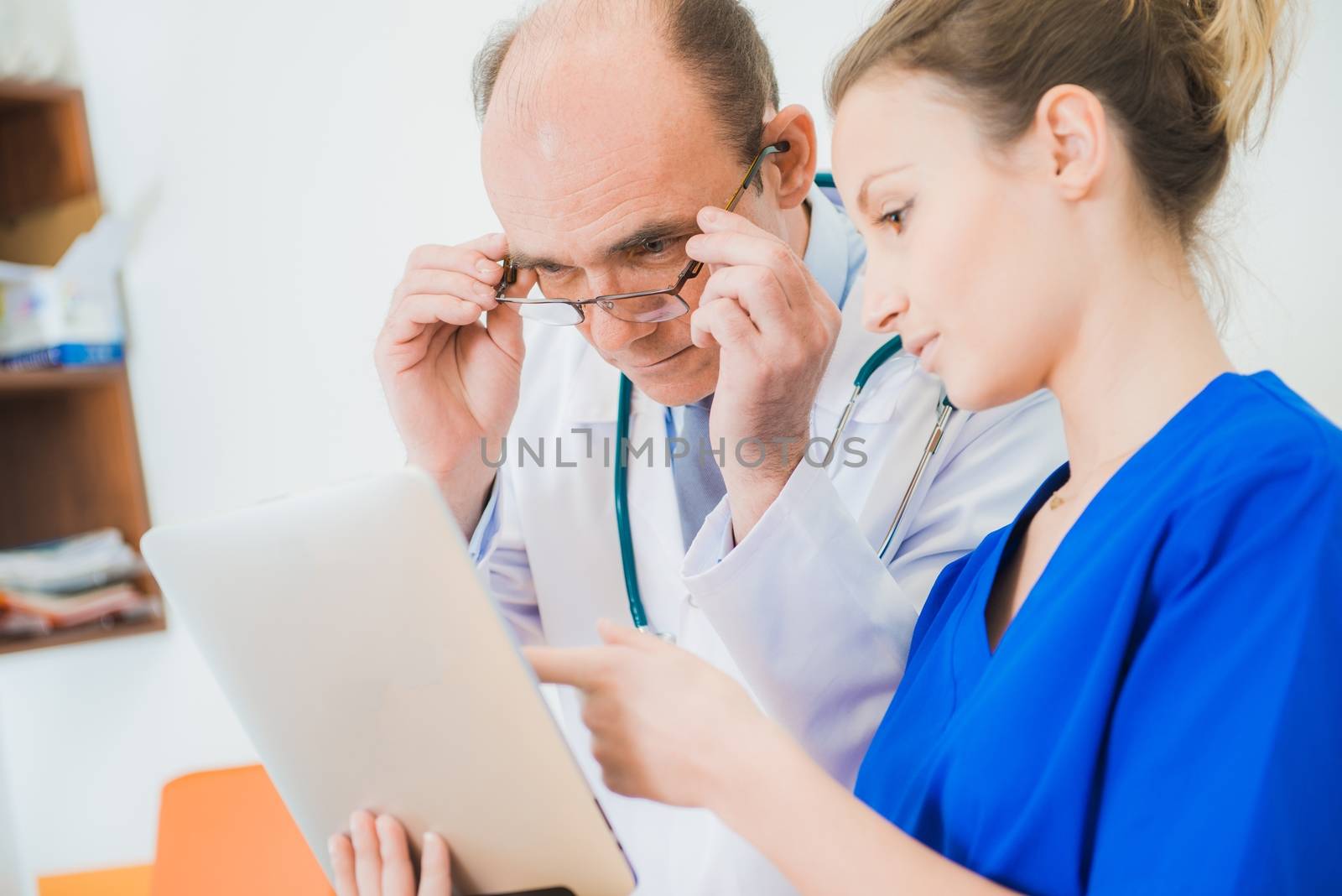 Medical Staff Team Work in the Hospital. Medical Doctor Consulting Test Results with Medical Practitioner.