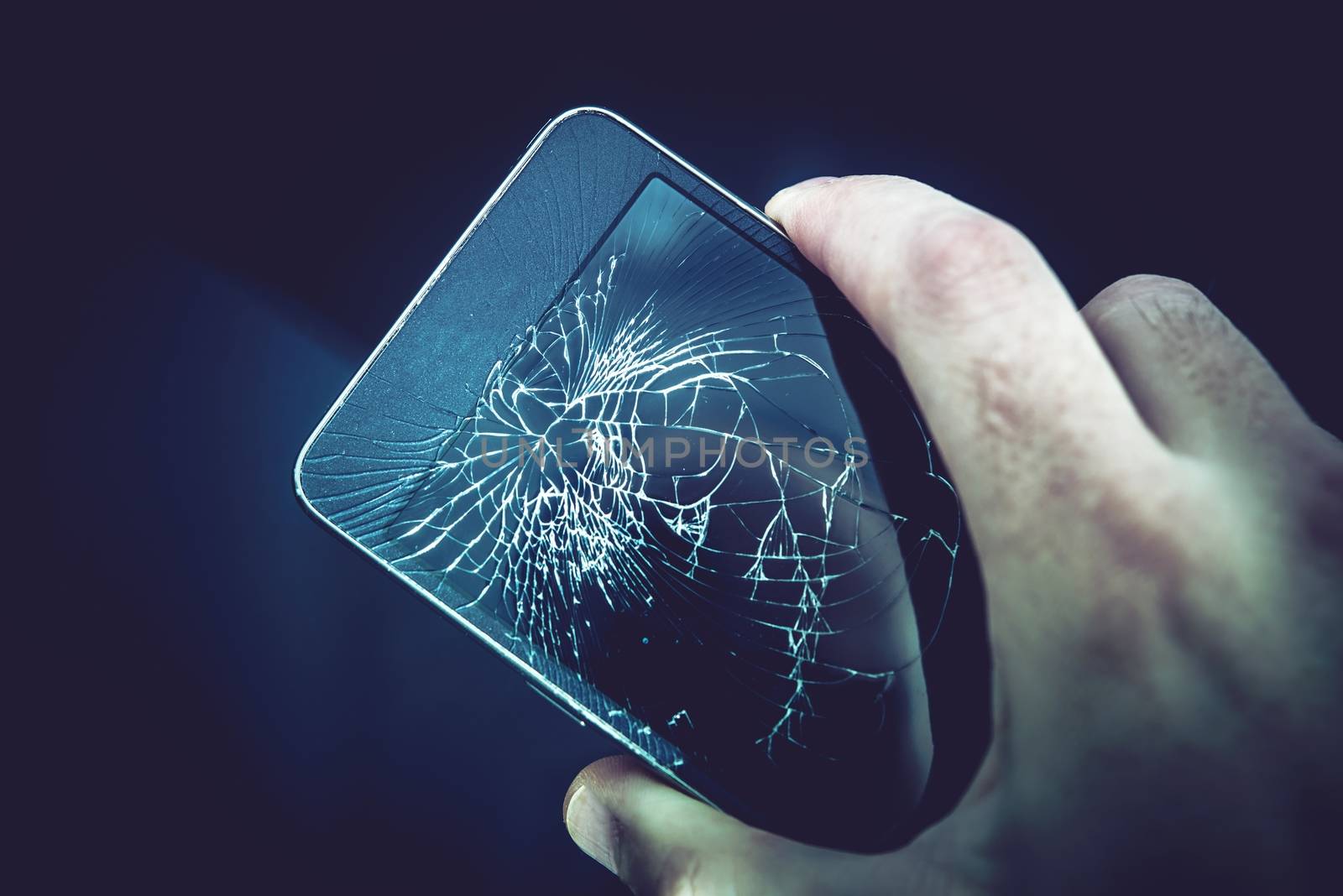 Damaged Smartphone Screen. Broken Mobile Phone in a Hand.