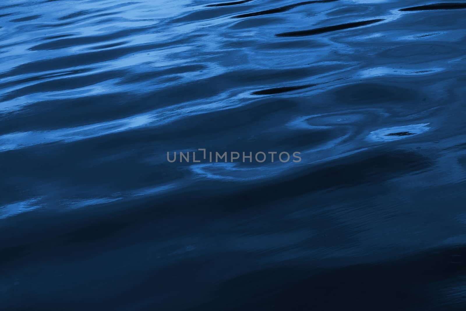 Deep Blue Ocean Surface Nature Photo Background. Dark Blue Wavy Water.
