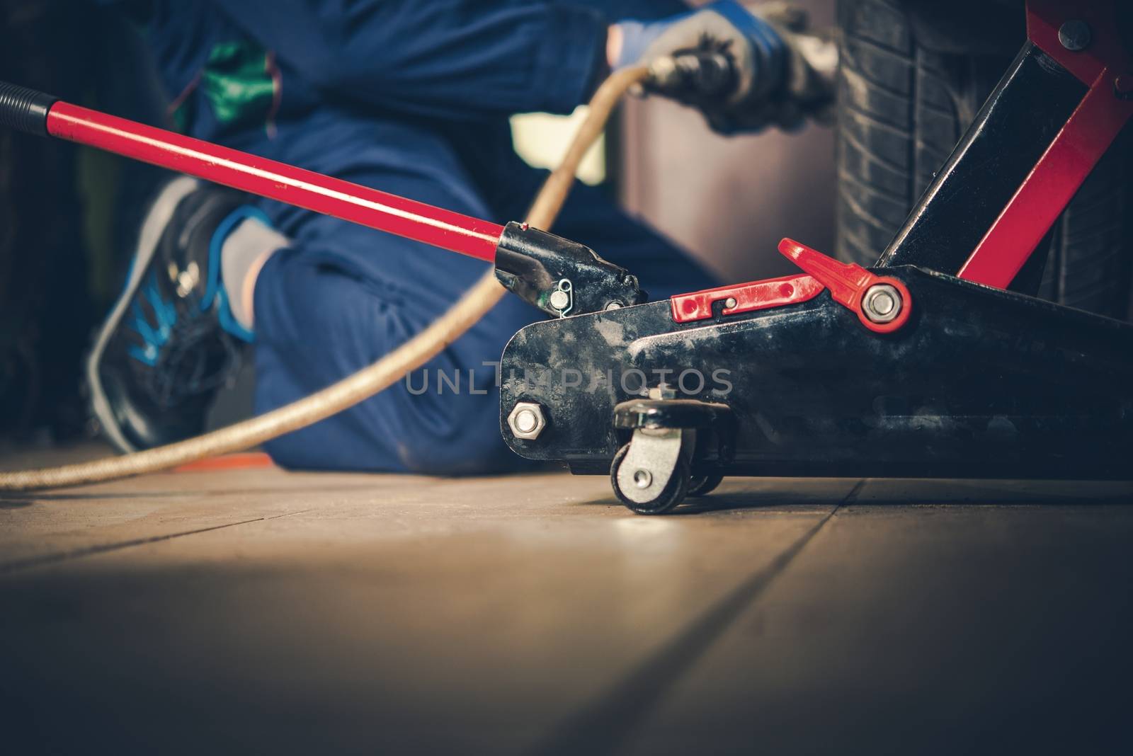 Repairing Car in the Garage. Portable Car Lift Closeup.