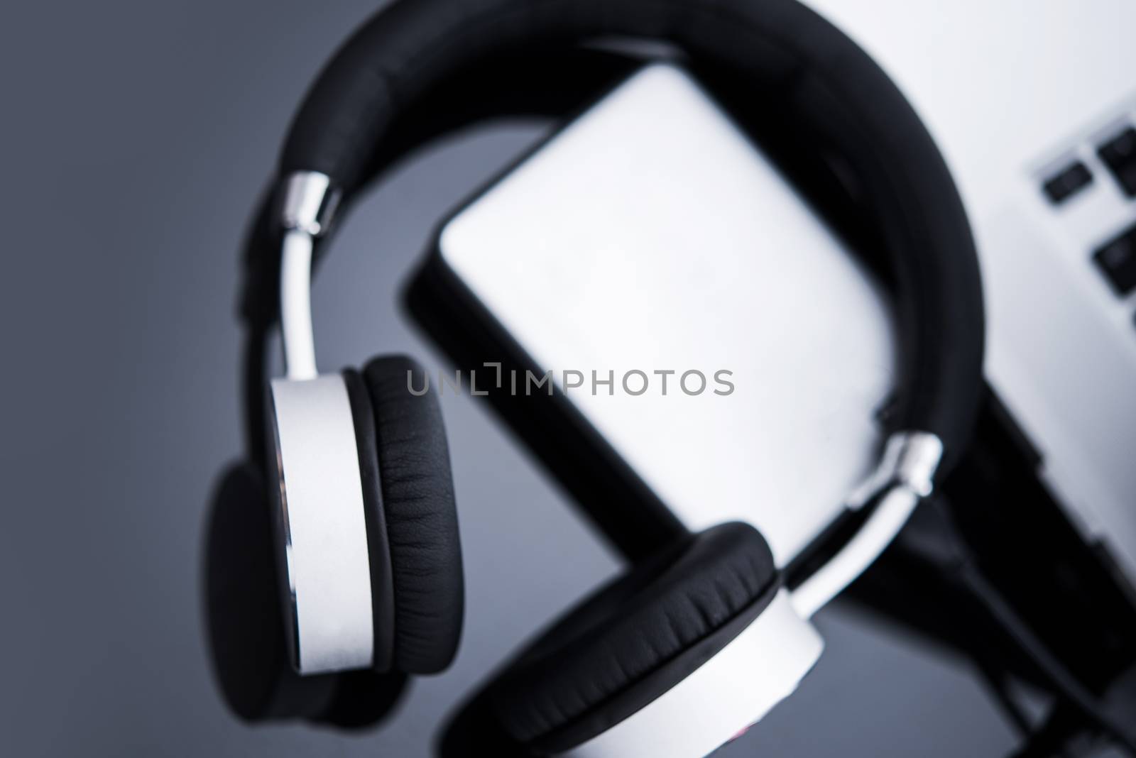 Online Music Concept. Modern Elegant Headphones and Laptop Computer.
