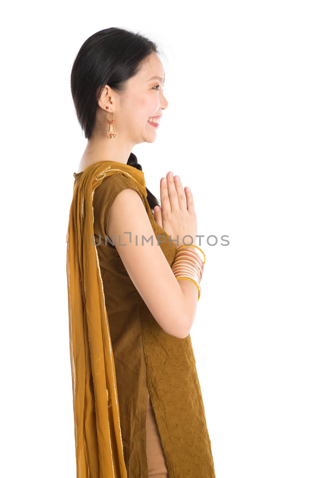 Young girl in Punjabi clothes greeting. by szefei