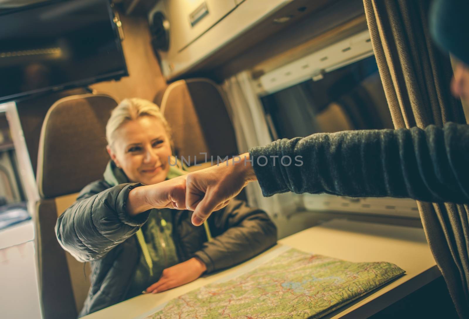 Approved RV Trip Fist Bump. Happy Couples in the Camper Motorhome Planning New Road For the Next Day Trip.