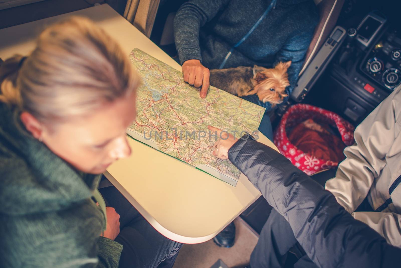 New Camper Trip Planning. Family Planning Next Camper Trip Using Paper Map. 