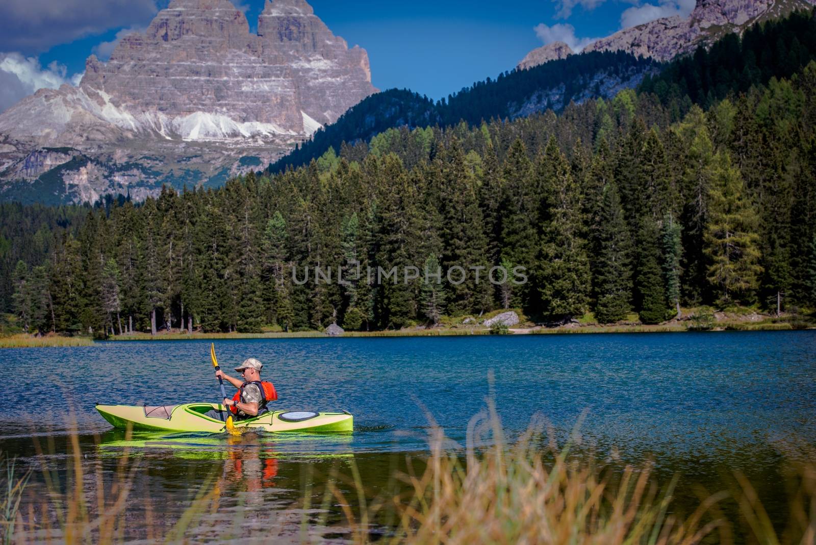 Scenic Mountain Lake Kayak Tour. Caucasian Men in the Kayak.