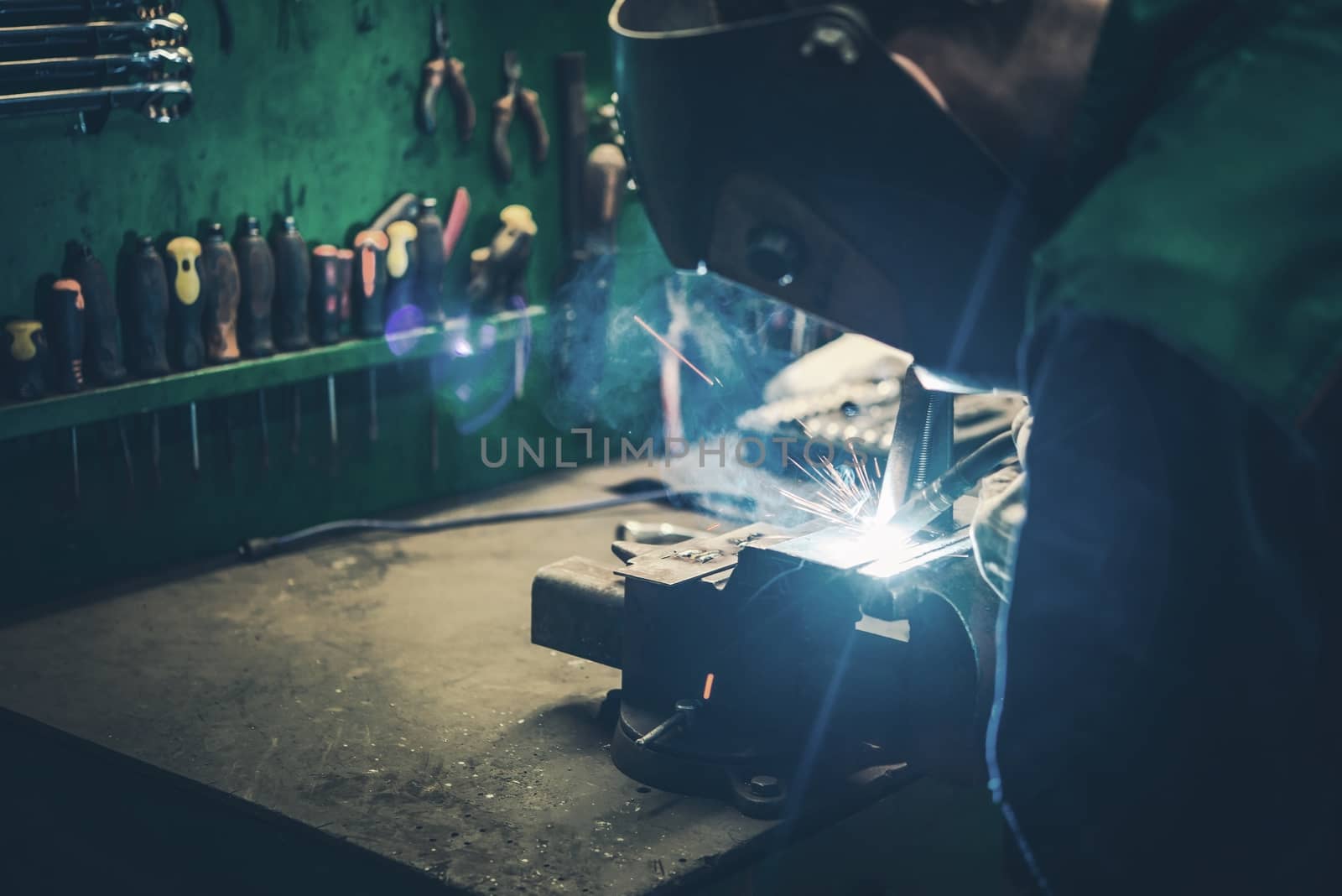 Welder Fusing Metal Together. Welding Metal Parts in the Small Workshop.