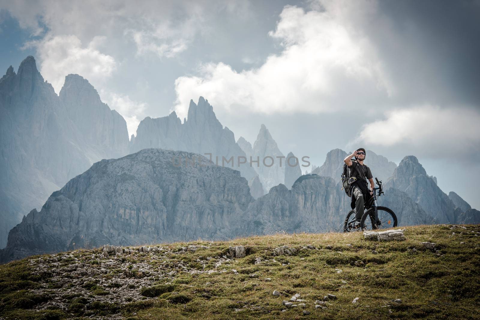 High Mountains Bike Ride. Caucasian Sportsman on the Ride Through Scenic Mountains Landscape.