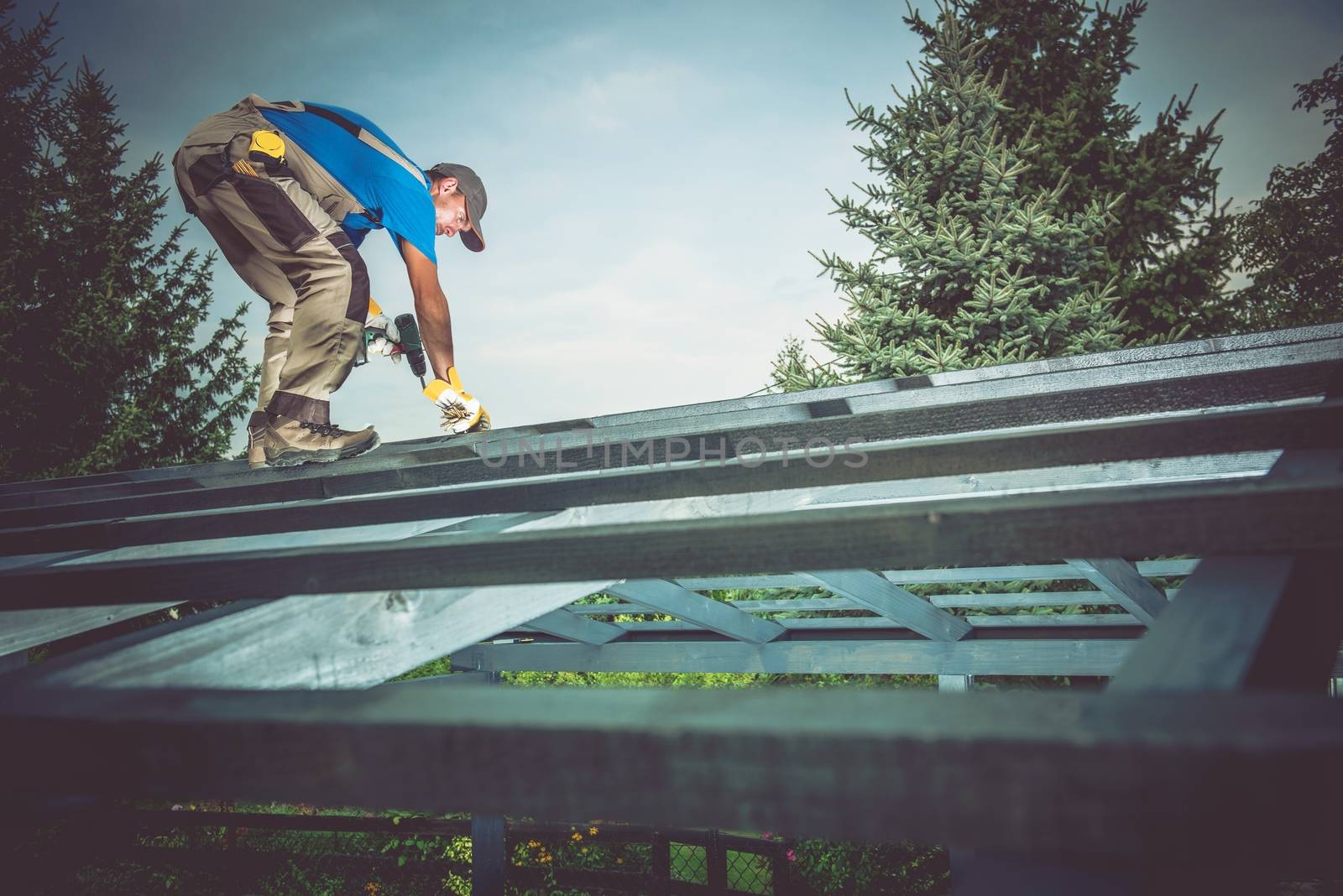 Wooden Construction Building. Caucasian Construction Builder Building Wooden Roof Structure.