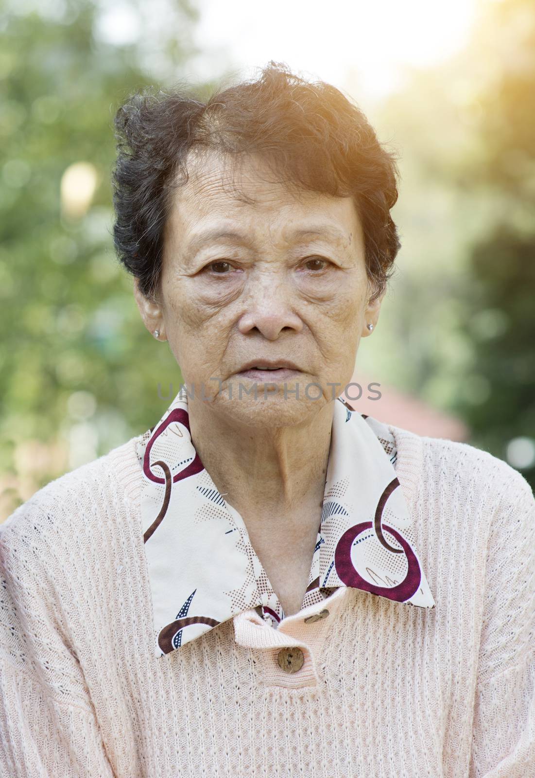 Sad Asian elderly woman  by szefei