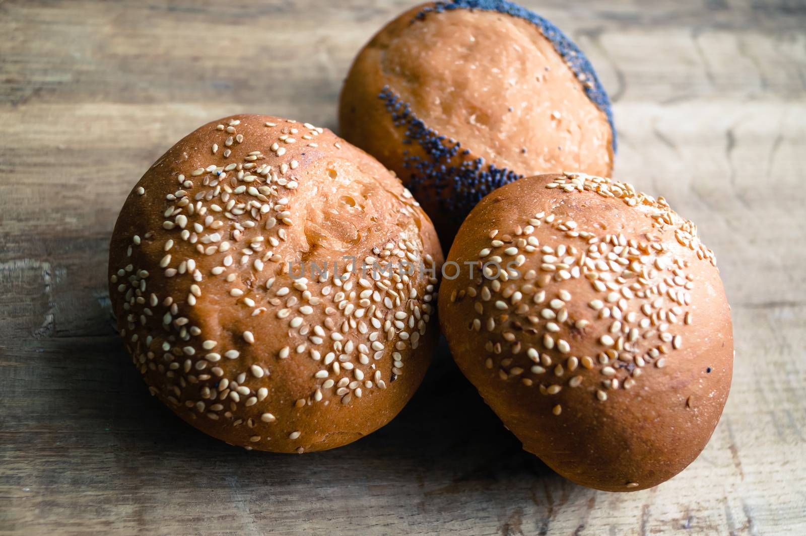 round loaves are with a poppy and sesame by Oleczka11