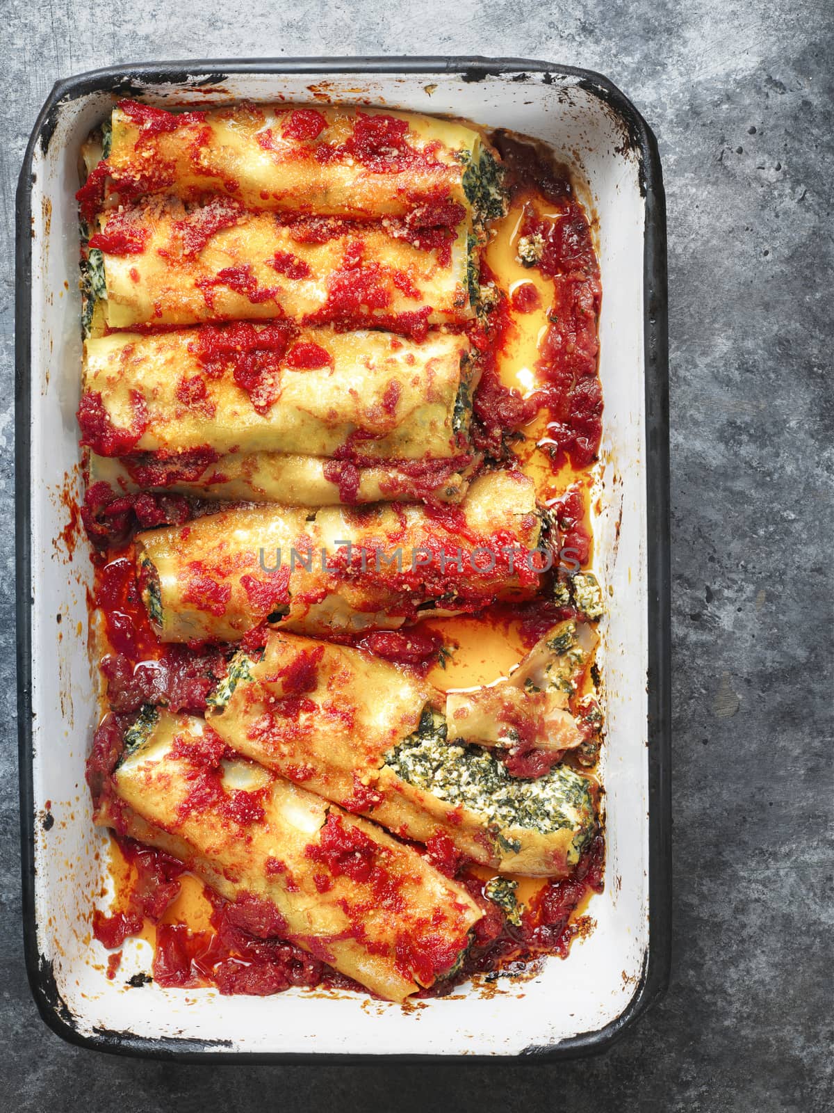 close up of rustic italian spinach ricotta cannelloni pasta