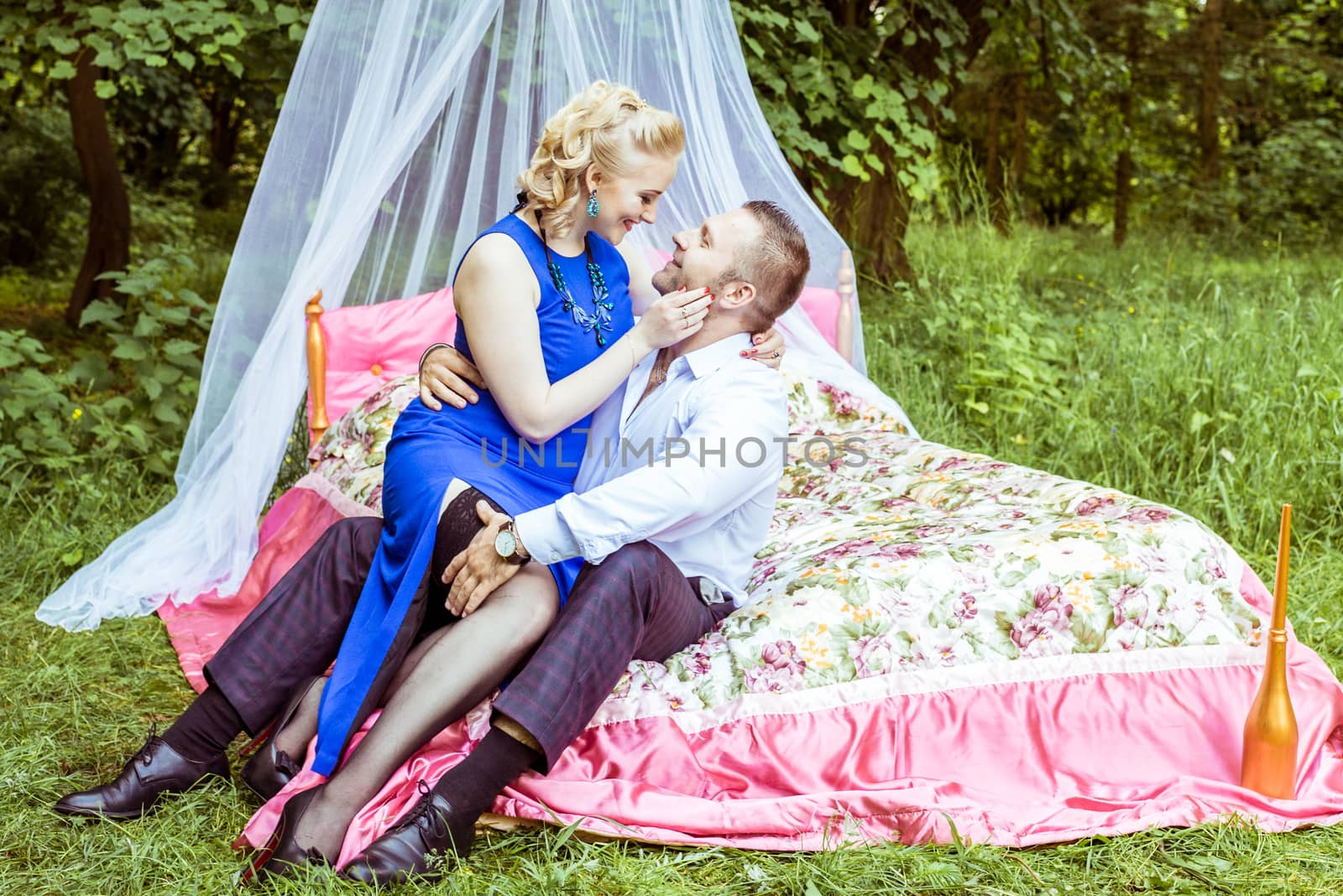 Man and woman sitting on the bed and looking at each other in the lawn in Lviv, Ukraine.