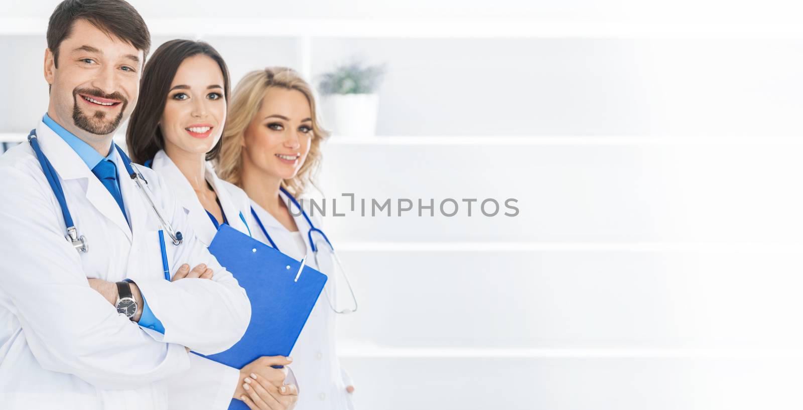 Team of doctors in a clinical office, white copy space