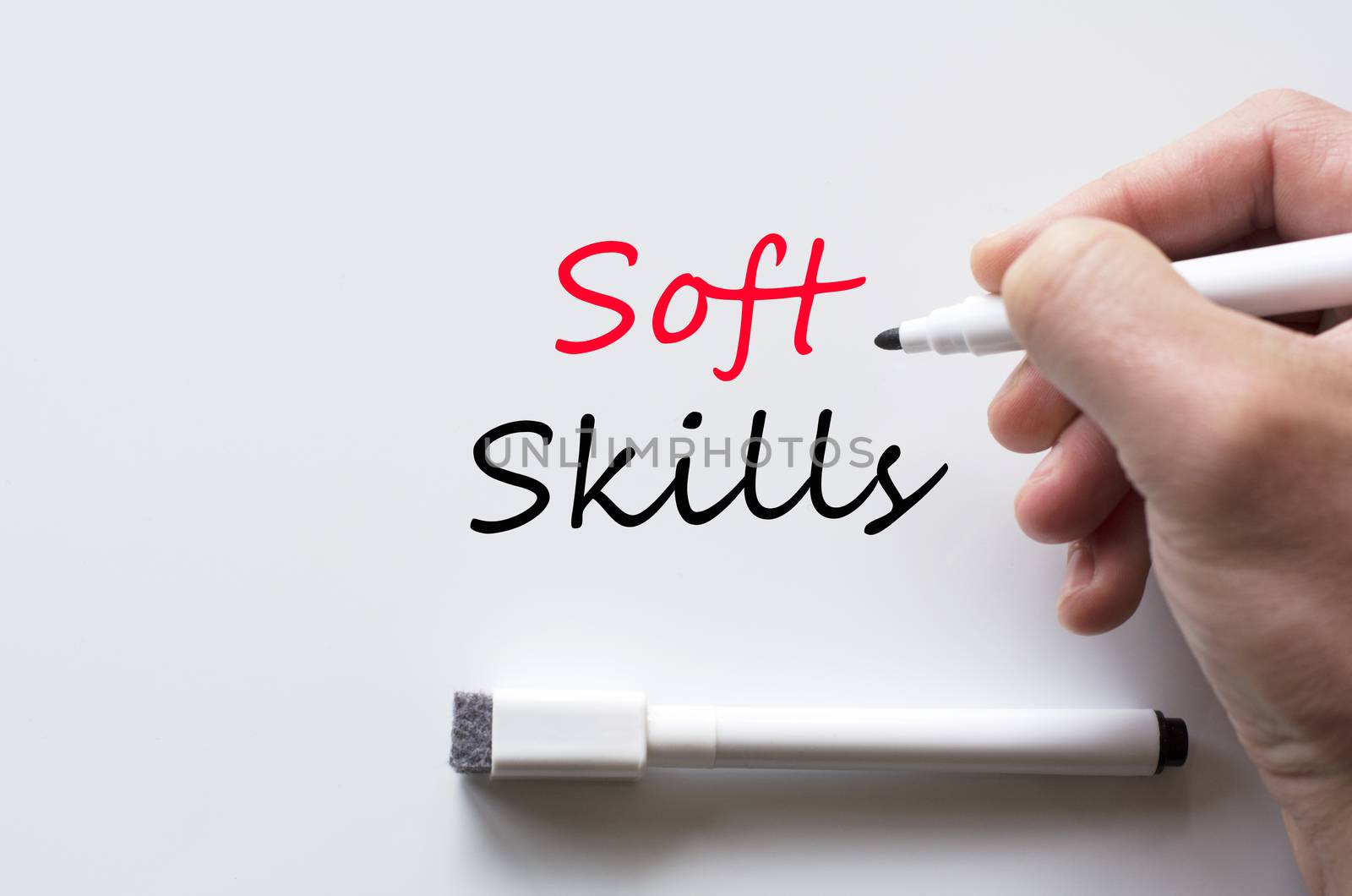 Human hand writing soft skills on whiteboard