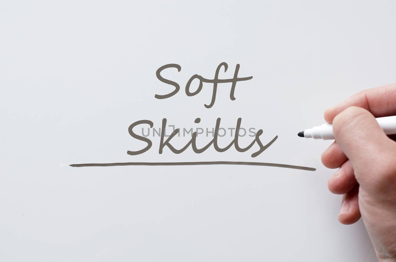 Human hand writing soft skills on whiteboard