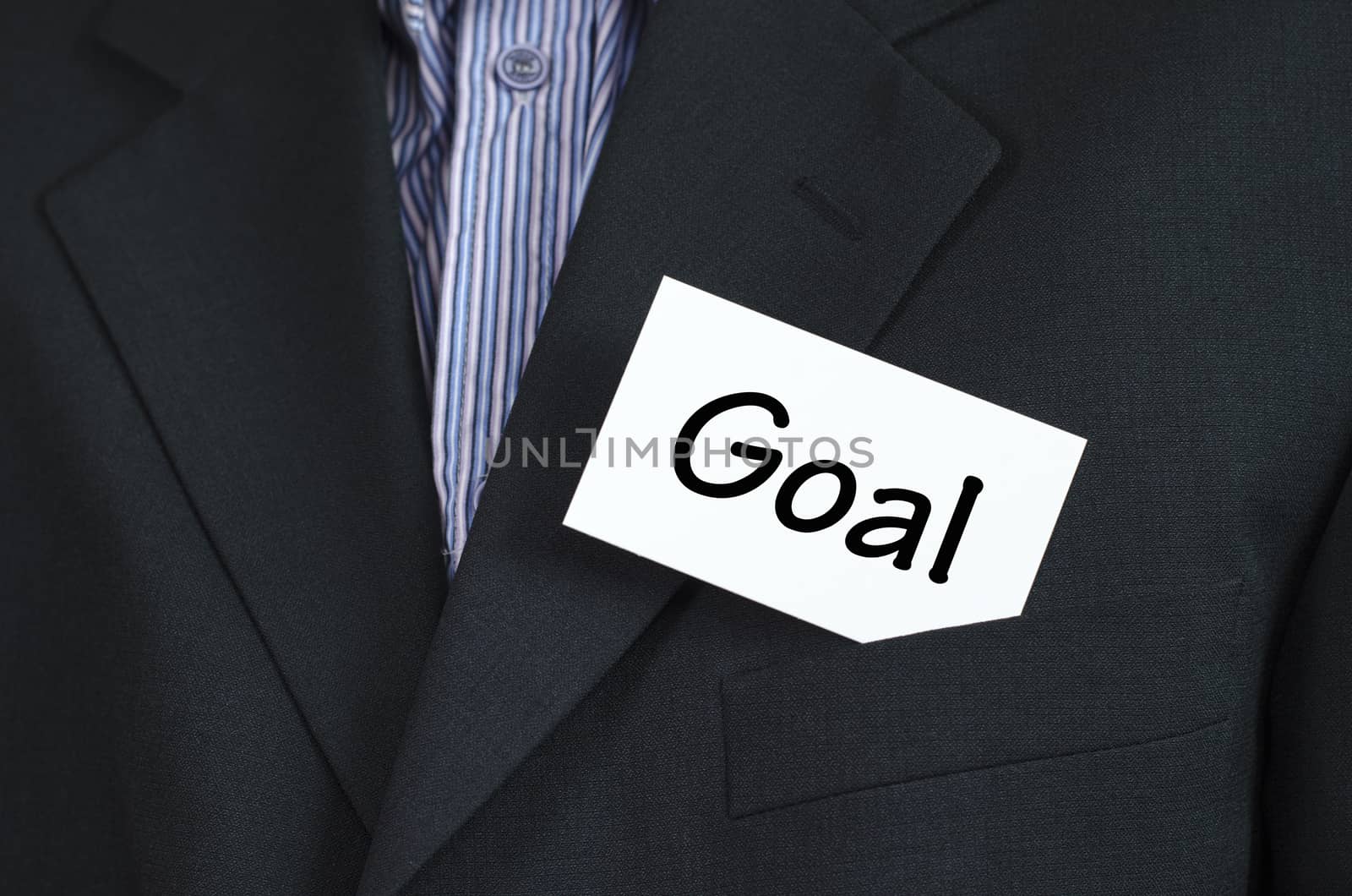 Goal text note concept over business man background