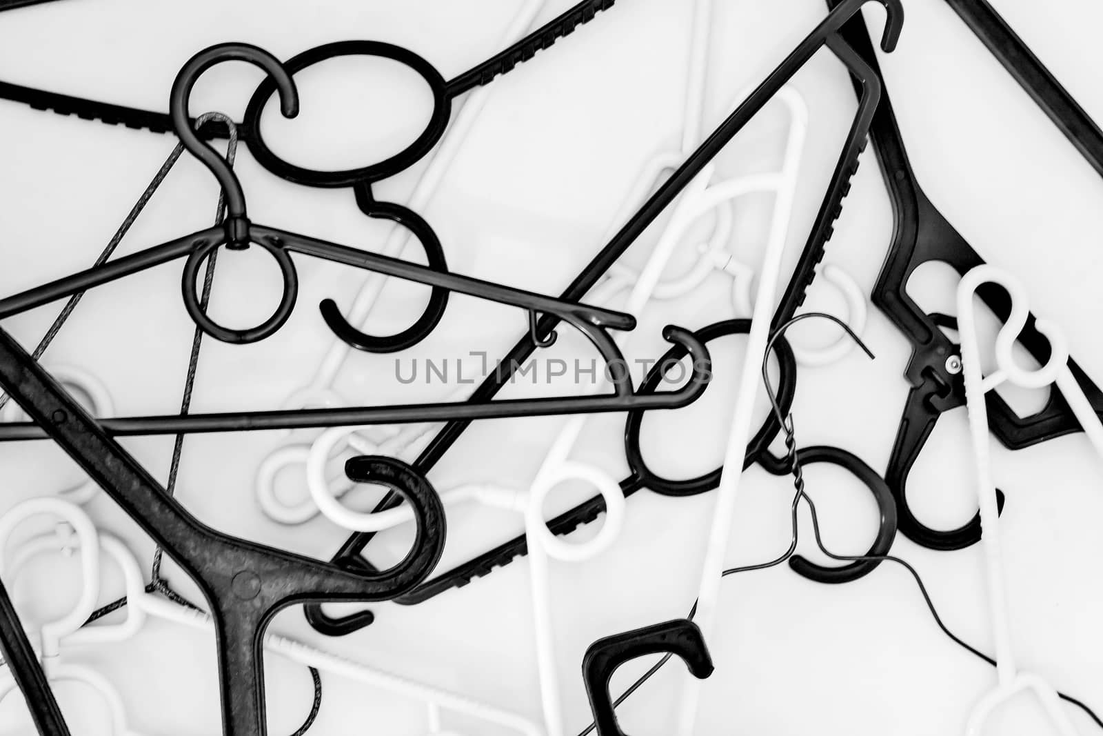 Many hangers of different shapes and colors, top view, white background.