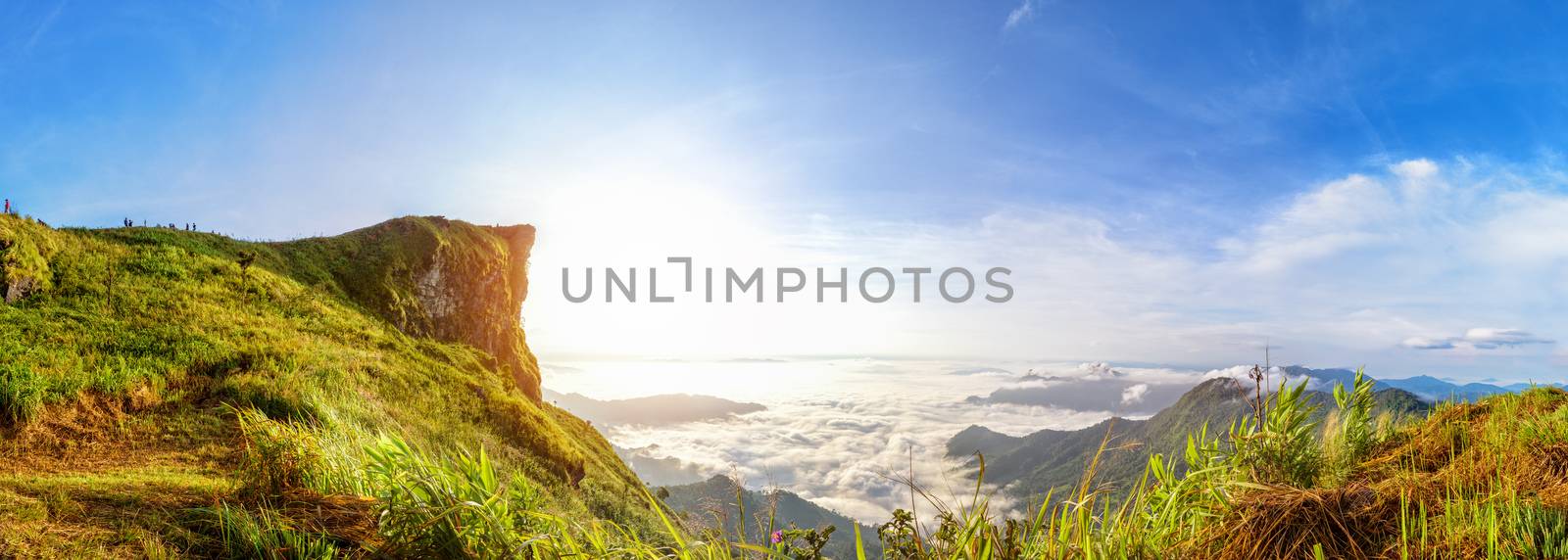 Panorama beautiful landscape nature of sunrise on peak mountain with sun cloud fog and bright colors of sky in winter at Phu Chi Fa Forest Park is a famous tourist attraction of Chiang Rai Province, Thailand