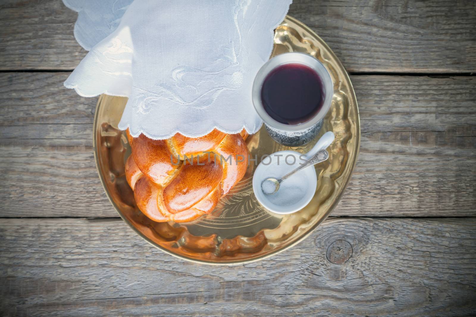 Wine, challah on a wooden surface. Jewish Sabbath
