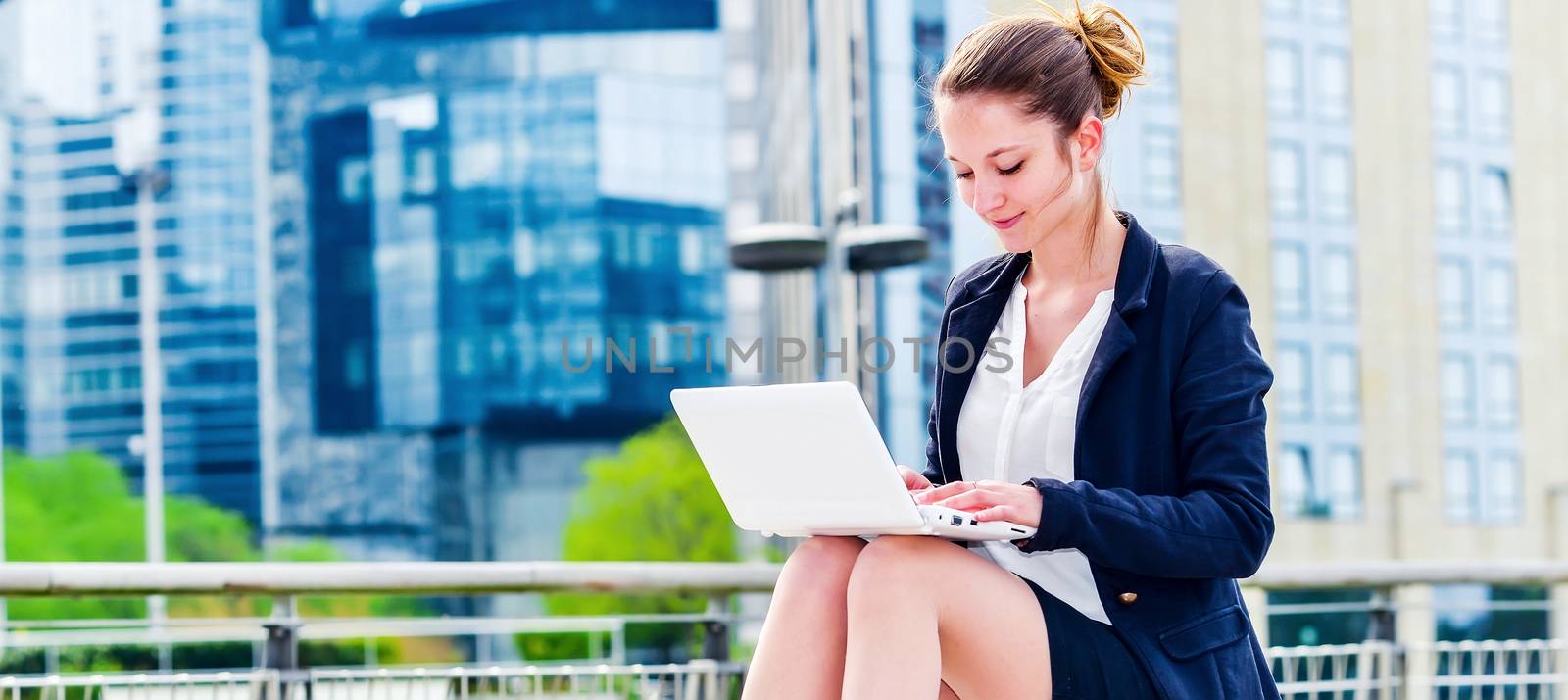 dynamic young executive girl working outside by pixinoo