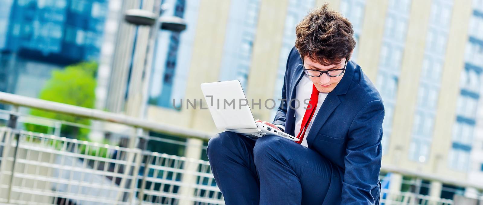 dynamic young executive working outside by pixinoo