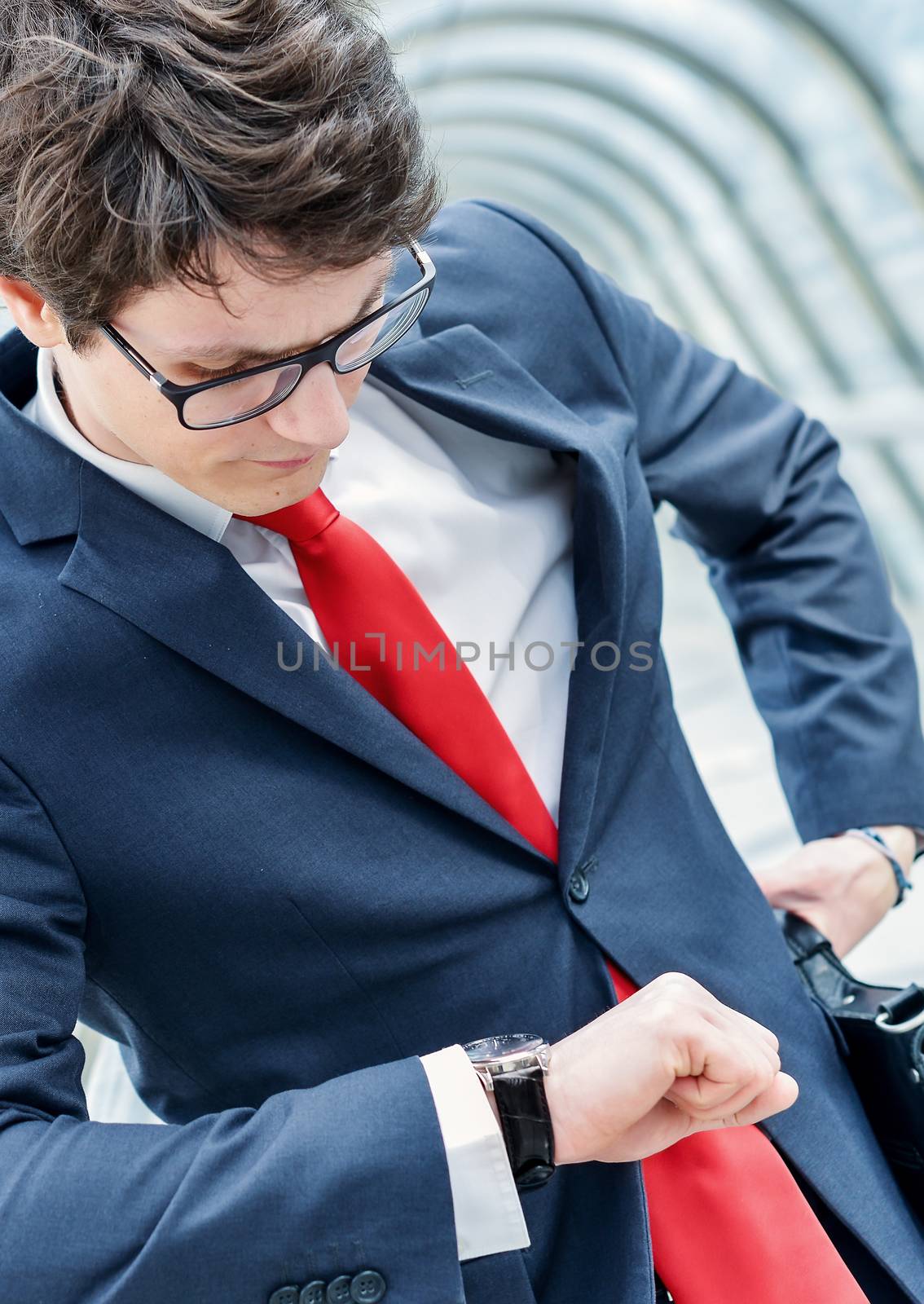 Young businessman watching his wrist watch