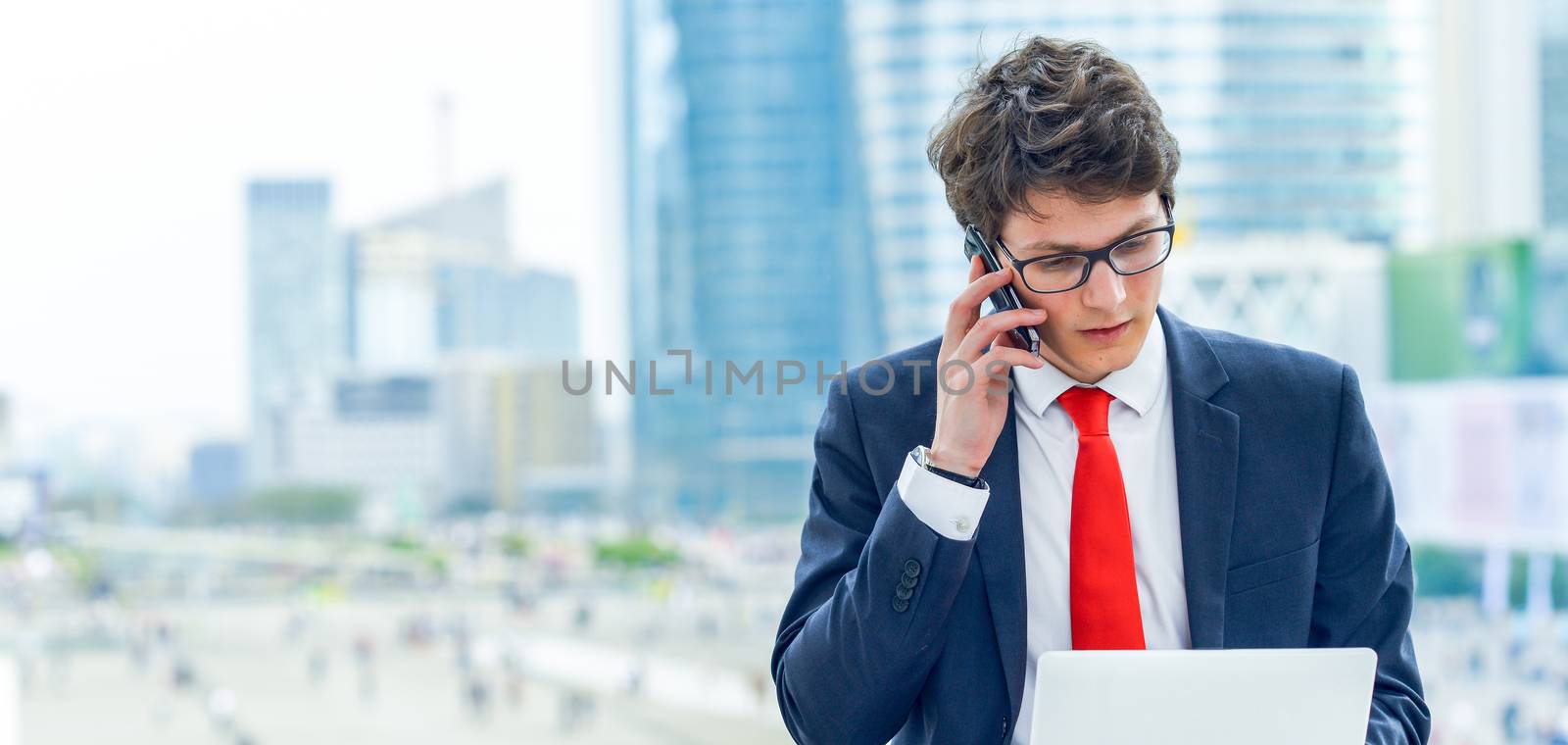 dynamic young executive working outside by pixinoo