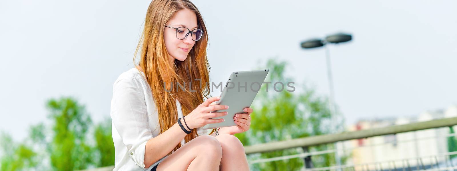 executive girl working on a touchscreen tablet by pixinoo