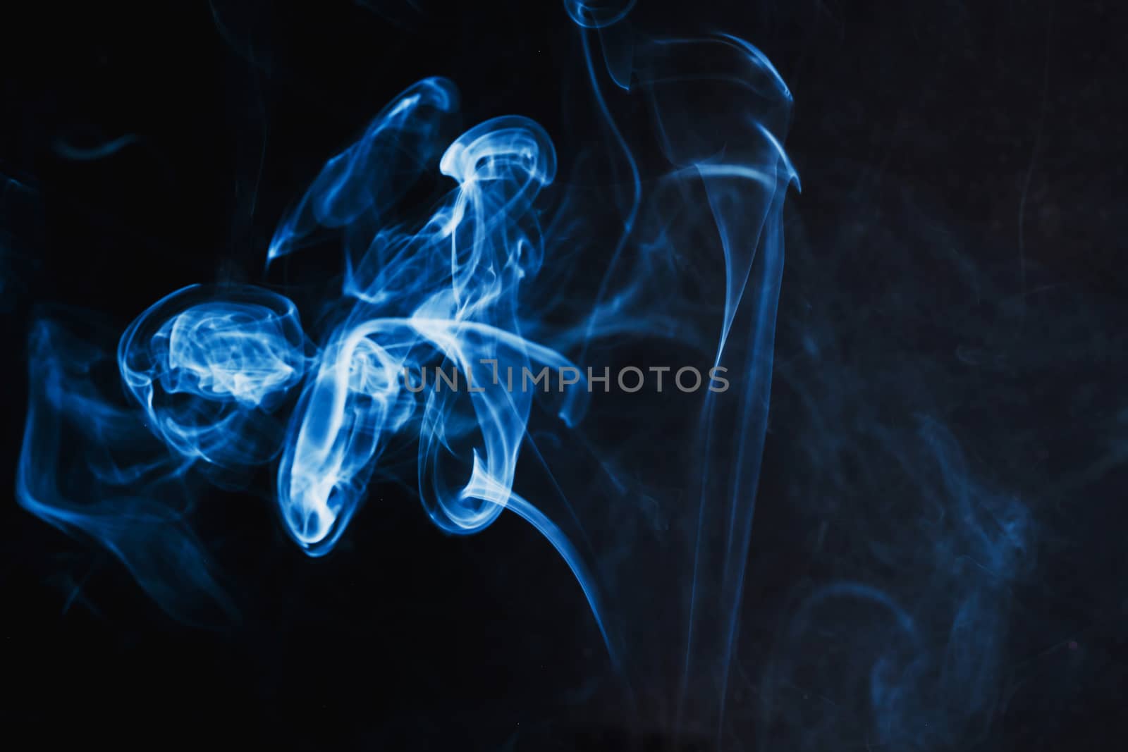 Abstract Blue Smoke on black background .