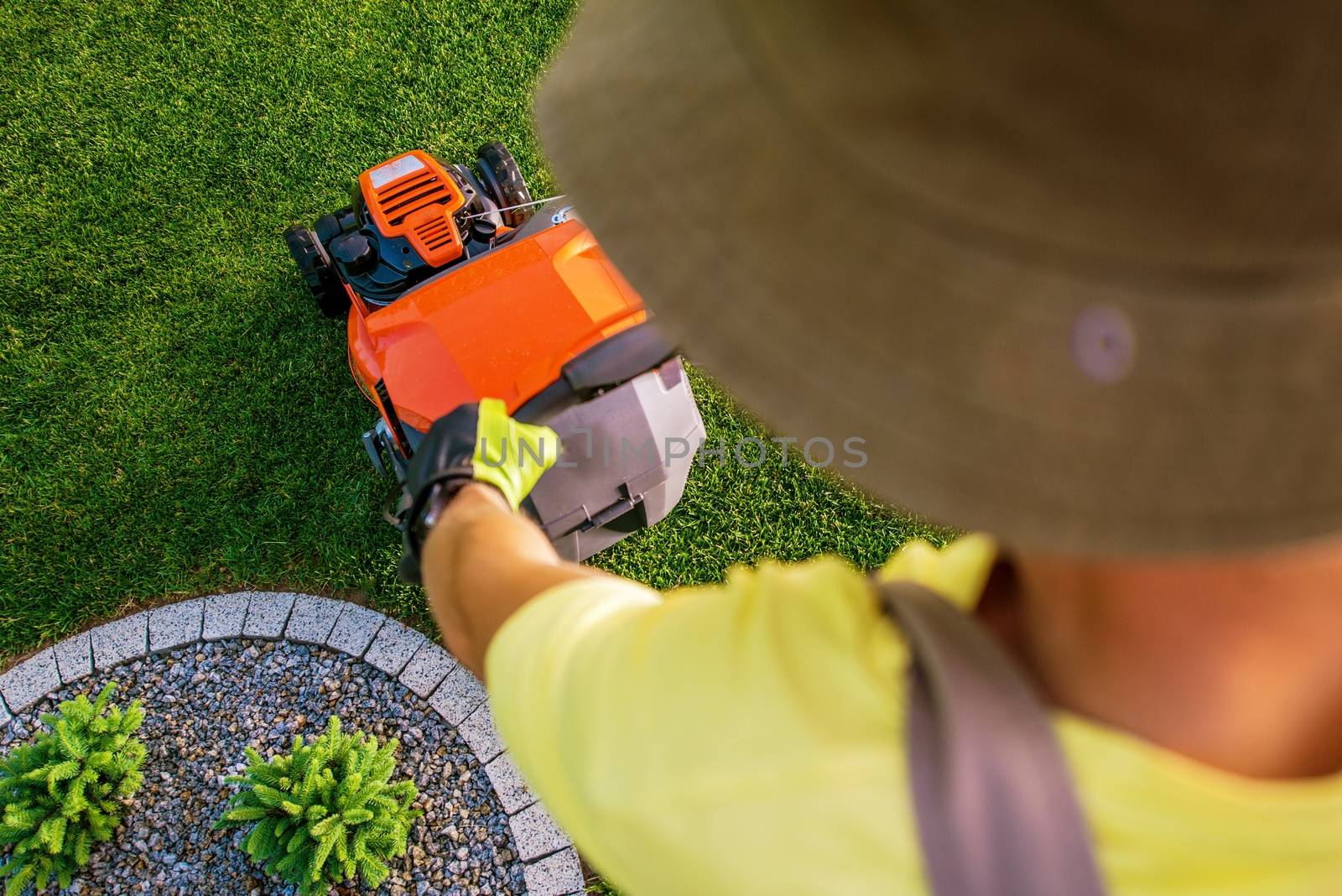 Gardener Mowing Grass Using Professional Gasoline Lawn Mower. Top View.