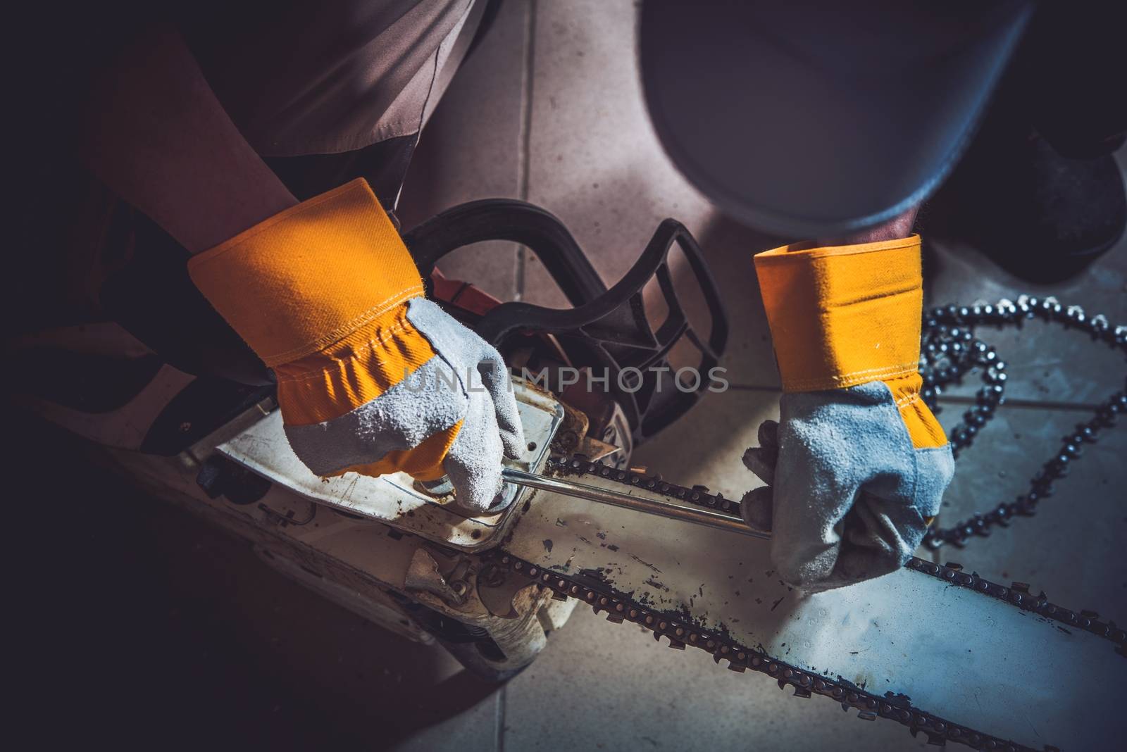 Replacing Wood Saw Chain Closeup Photo. Fixing Gasoline Chain Saw