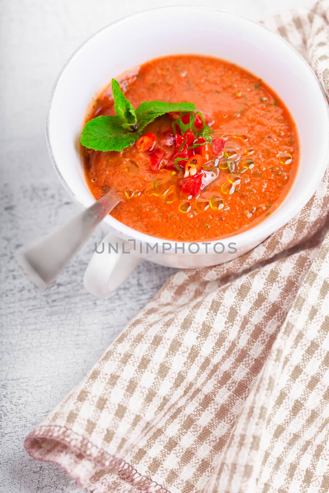 Bowl of fresh tomato soup gazpacho on the table