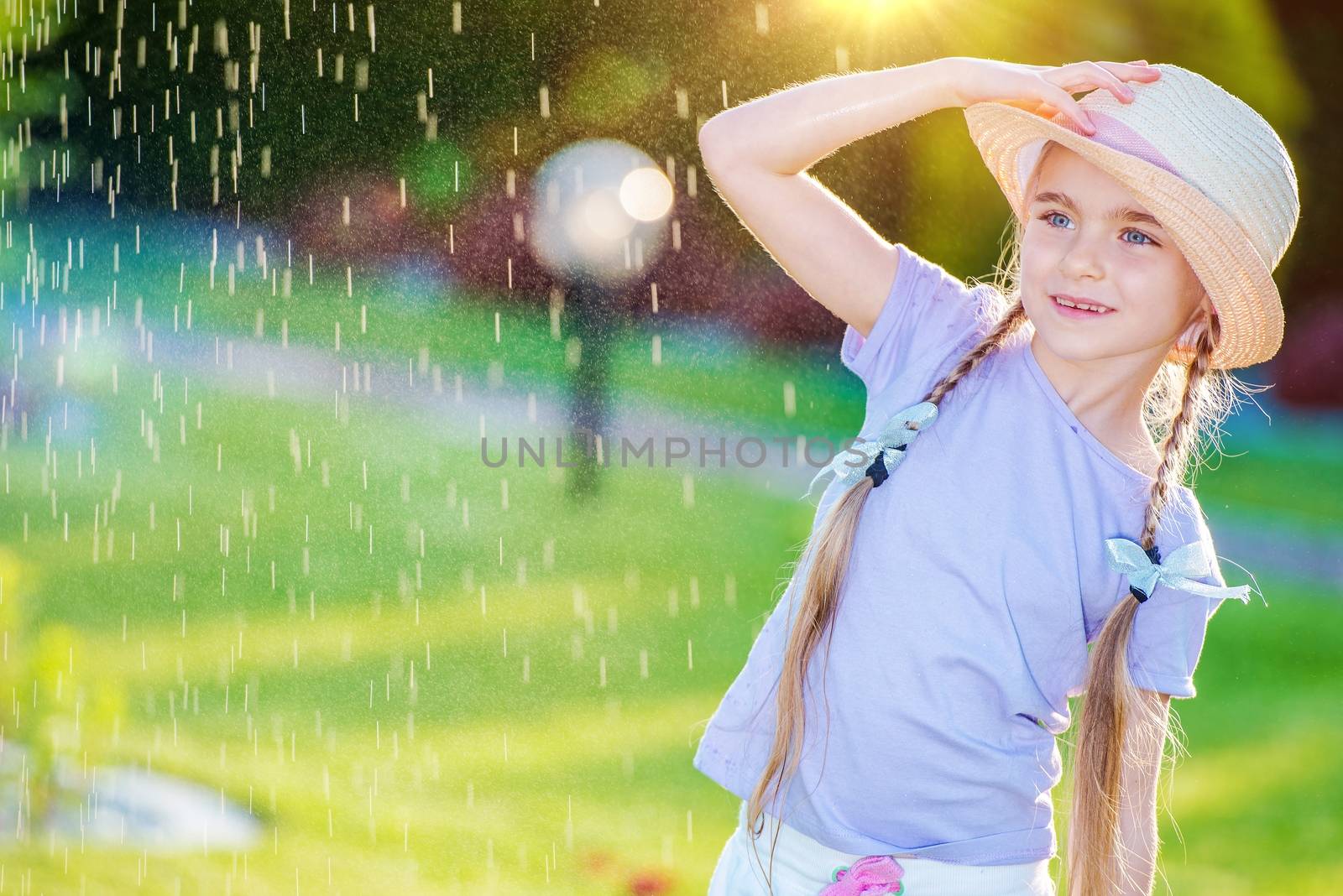 Summer Day Fun. Little Caucasian Girl in a Hat Having Fun in the Garden.