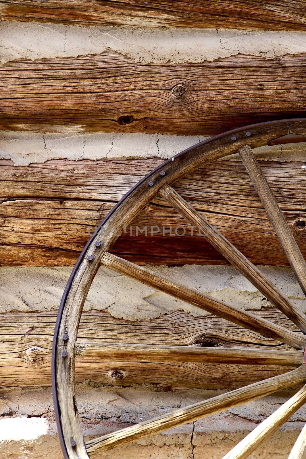 Horizontal Logs Wall and Old Vintage Wood Wheel. Vertical Photography