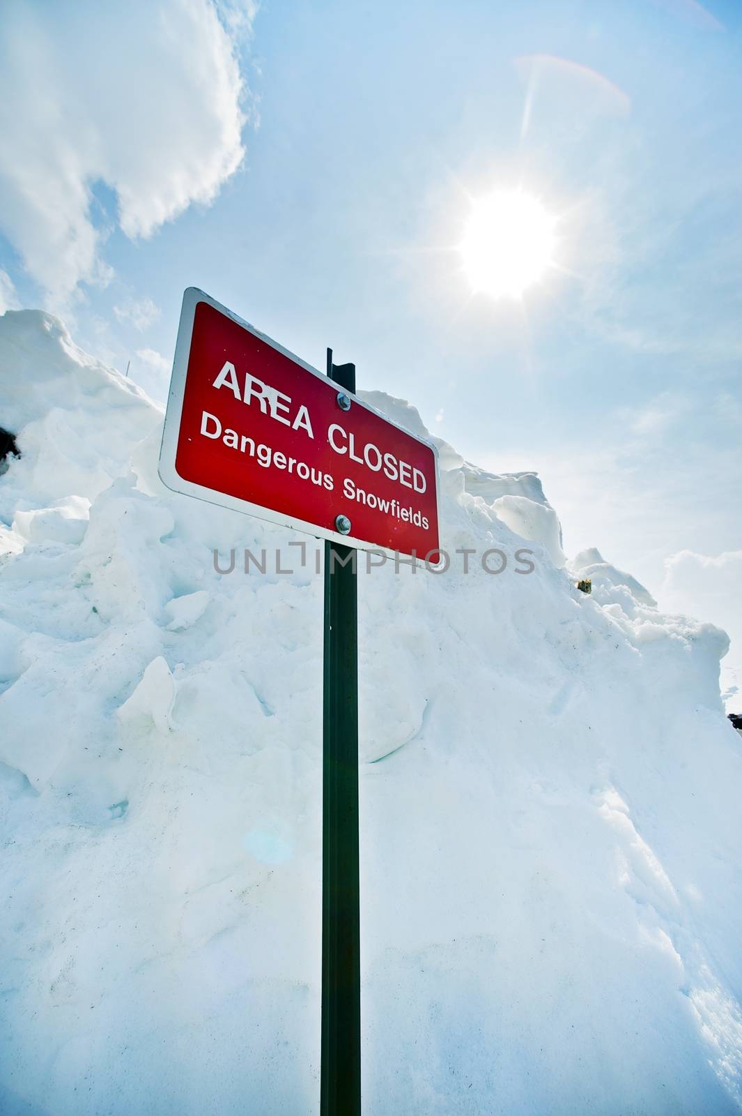 Mountain Sign: Area Closed - Dangerous Snowfields. Vertical Photography. Sign Location: Rocky Mountains National Park.