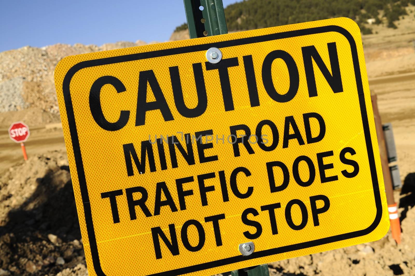 Yellow Caution Sign. Mine Road Traffic Does Not Stop. Gold Mine Signage.