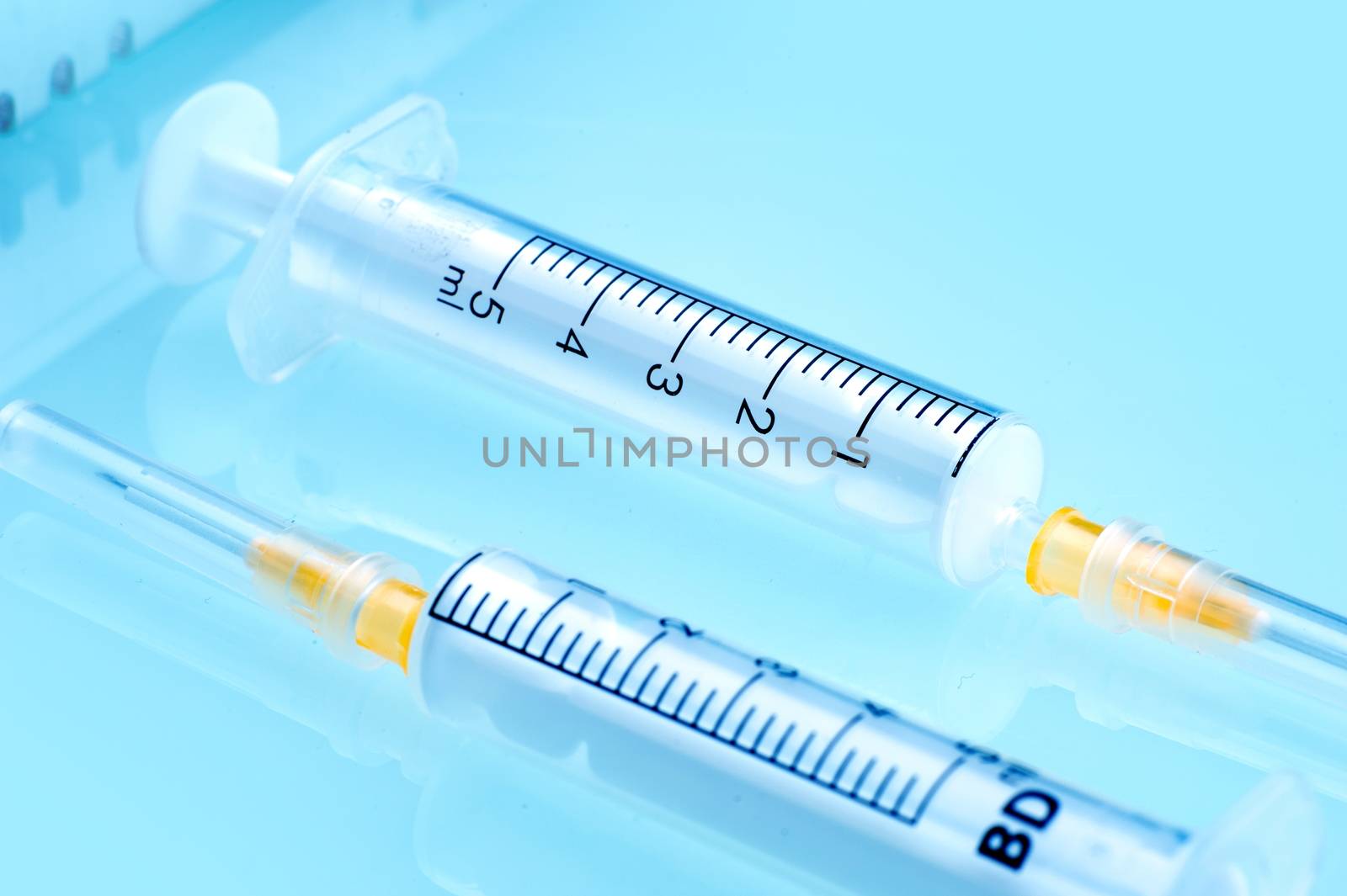 Two Plastic Syringes at Doctor Desk. Health and Beauty Photo Collection.