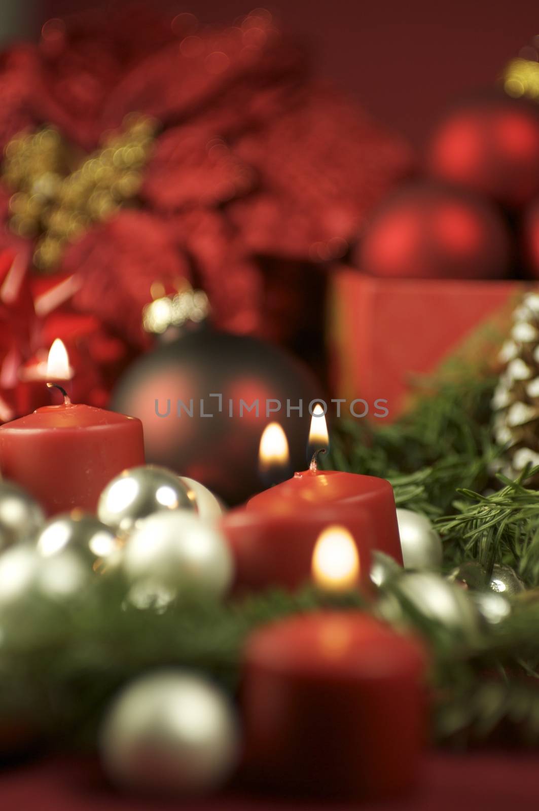 Christmas Time Decoration. Beautiful Composition with Red Burning Candles and Christmas Ornament.