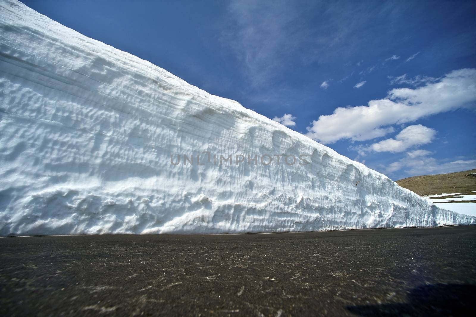 Large Snowfields in Colorado Mountains. Early Spring in the Rocky Mountains National Park (USA). Pavement Level Shot.