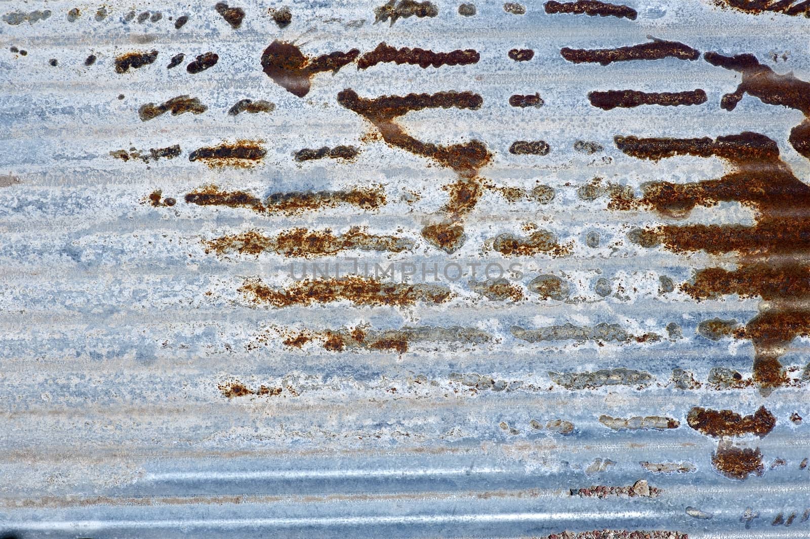 Corroded Metal Sheet Background. Corroded Folded Metal Sheet. Some Old Paint Exists.