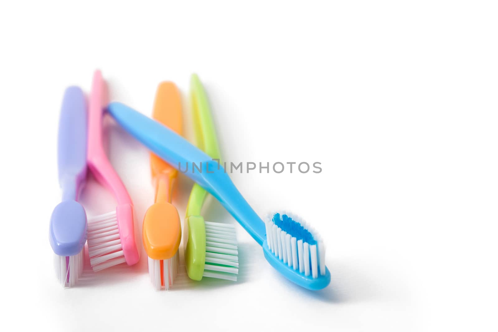 colorful toothbrushes on white background