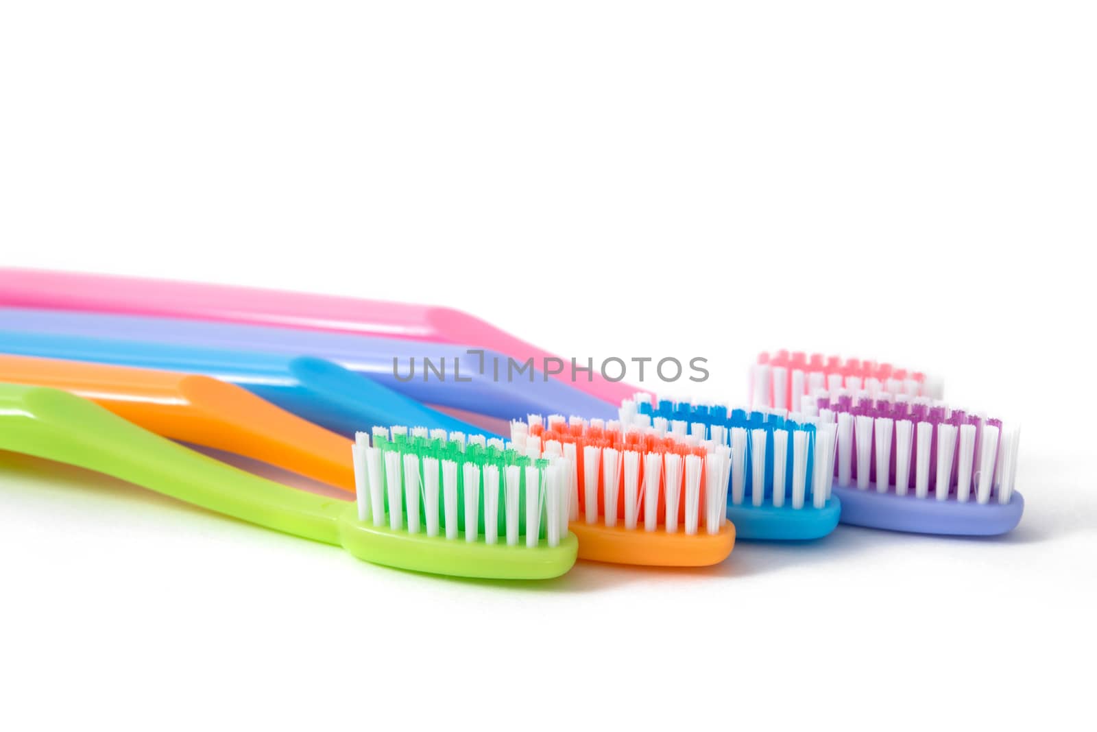 colorful toothbrushes on white background