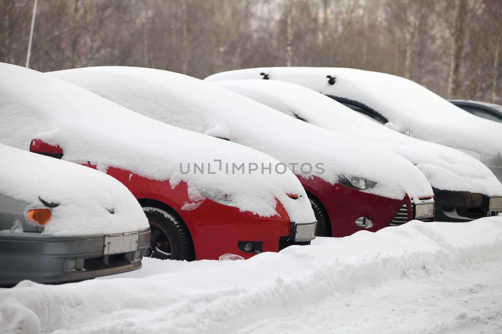 Parking row of cars covered with snow, on road big snowdrifts, snow storm, Cold winter,
