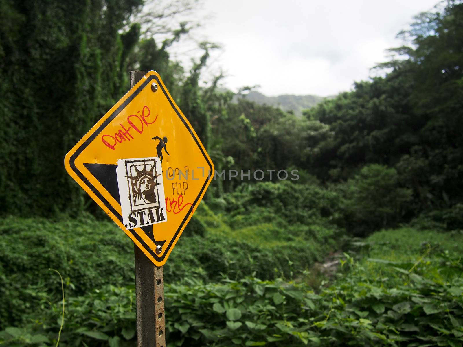 A warning sign along a hike on the island of Oahu in Hawaii has been defaced with graffiti.