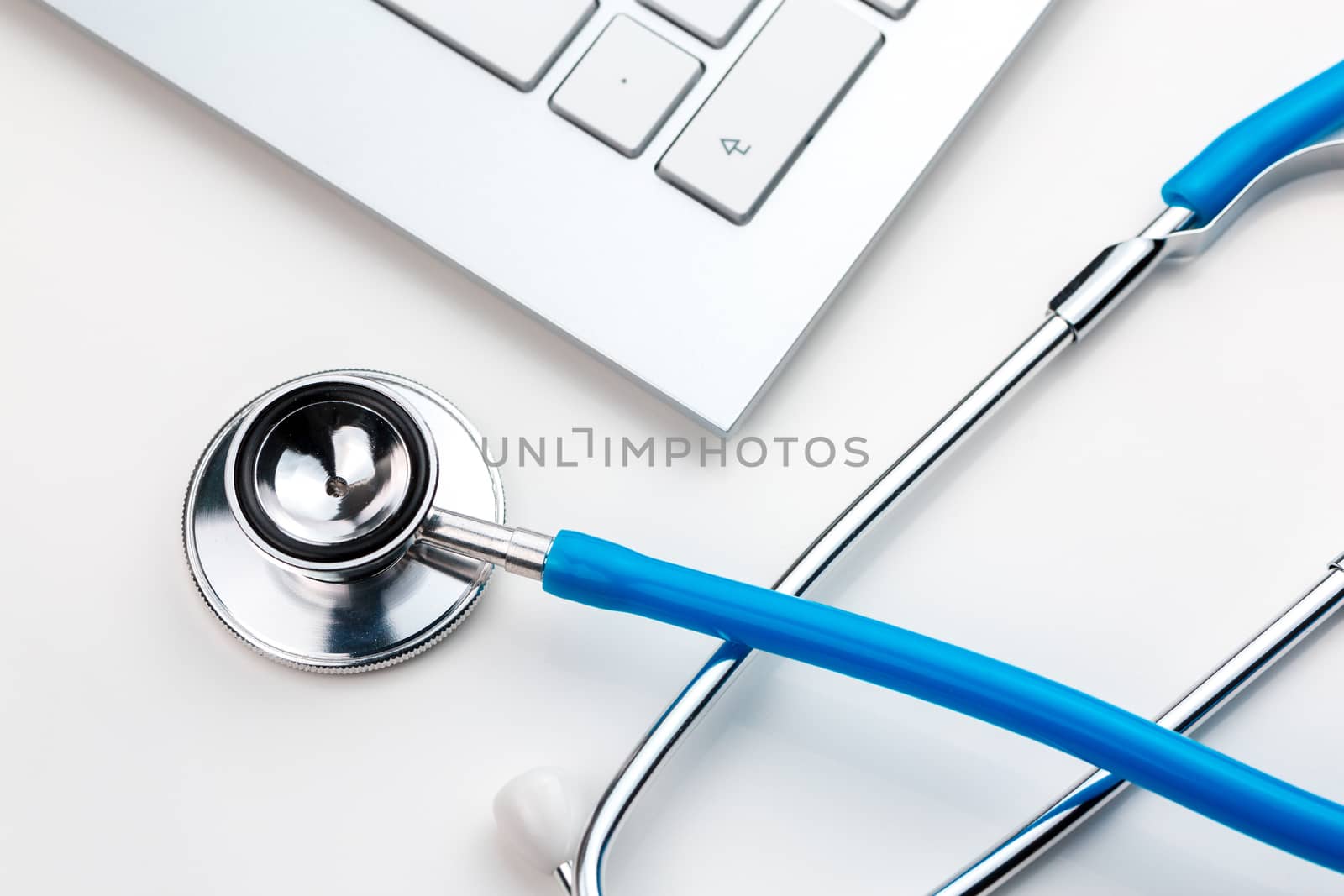 A medical stethoscope on keyboard