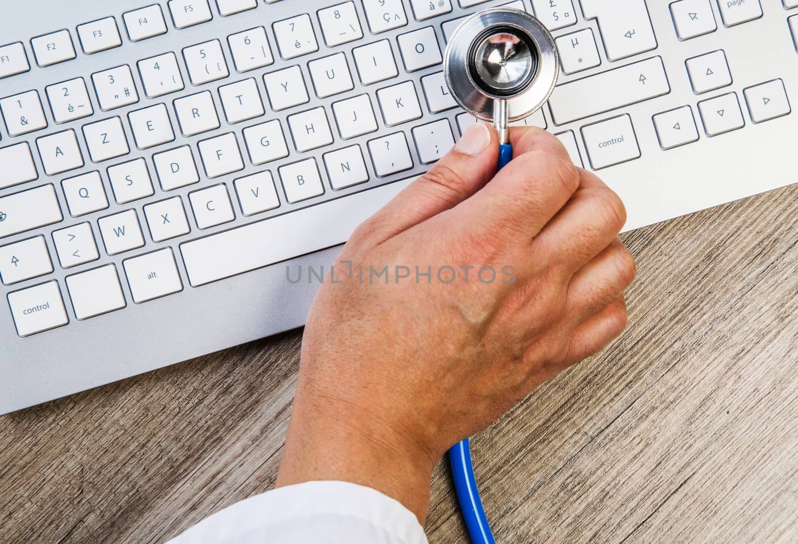 Expert examining a keyboard with stethoscope by pixinoo