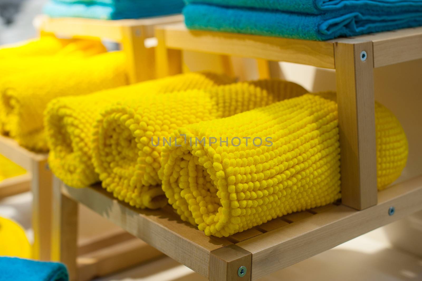 yellow towels on the shelf in the closet by timonko