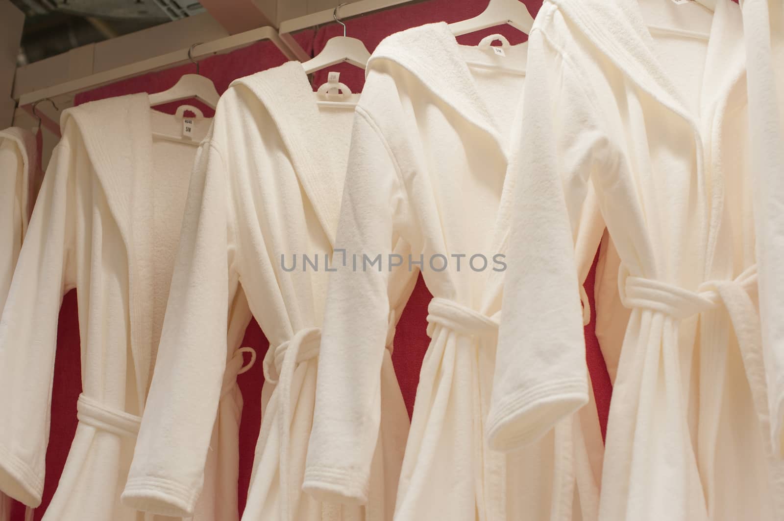 White terry robes in the closet on the trembler