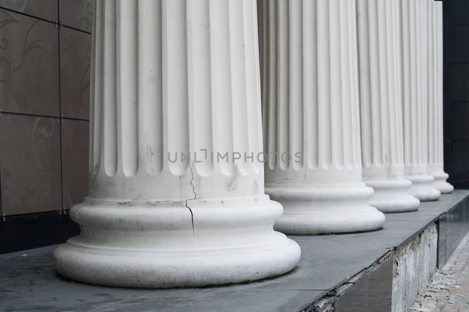 White columns on the facade of the building.